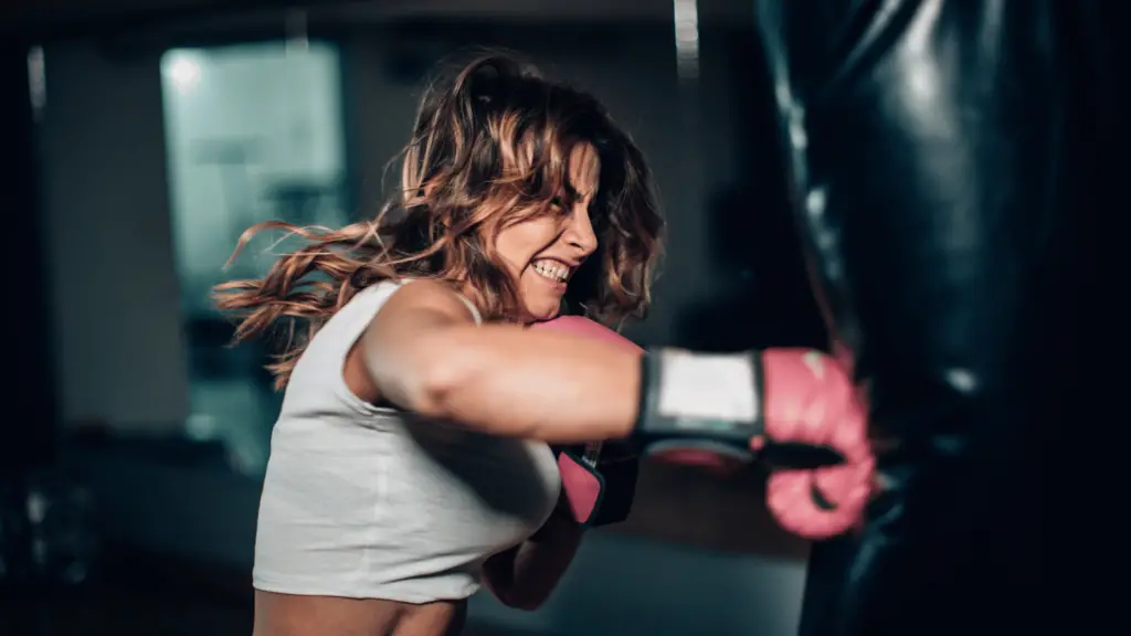 Woman exercising using punching bag 