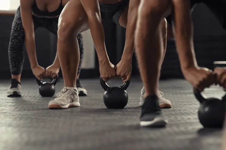 athletes lifting kettle bells