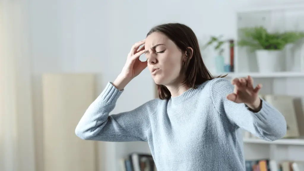 Woman feeling dizzy at home