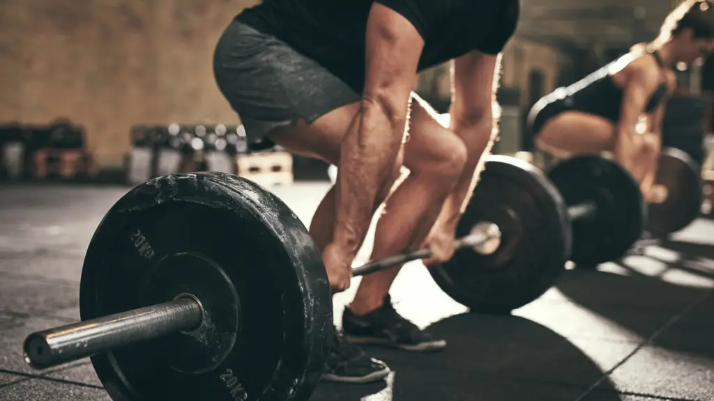 Man and woman doing deadlifts