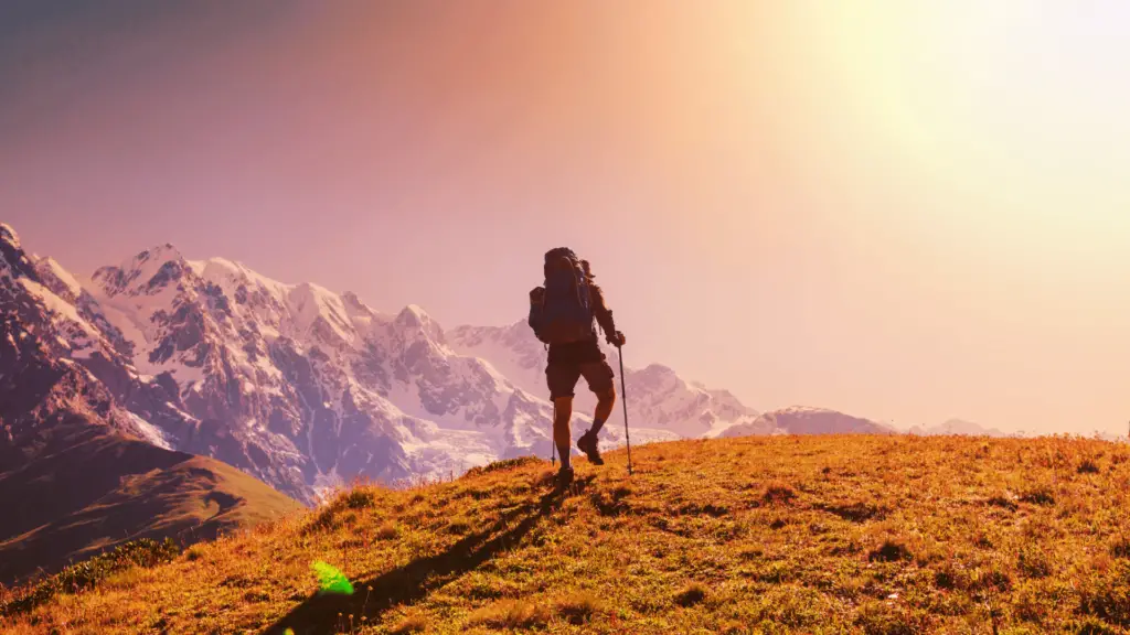 A man hiking at sunset