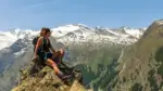 Woman sitting on top of a mountain after a hike