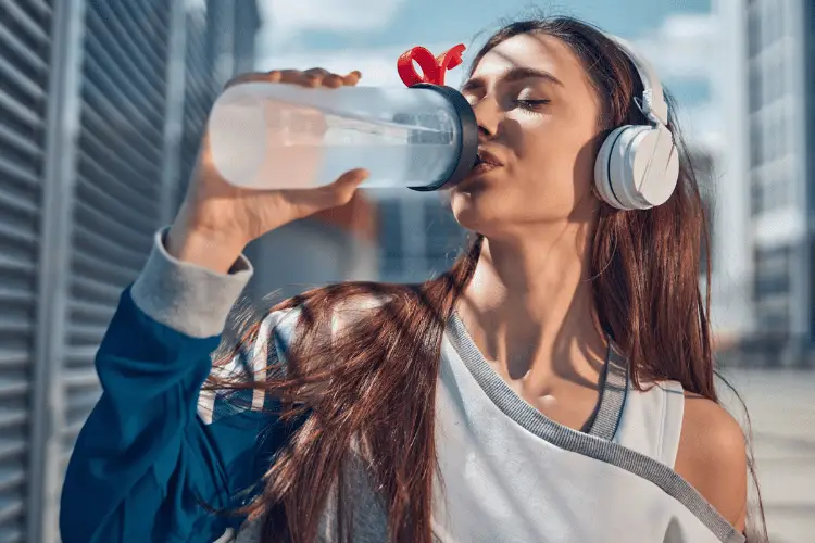 a woman drinking during her run