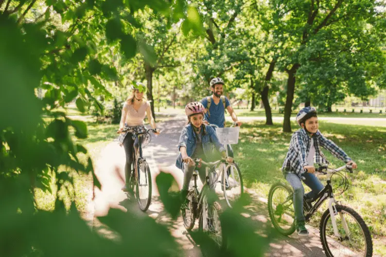 A family cycling in public park