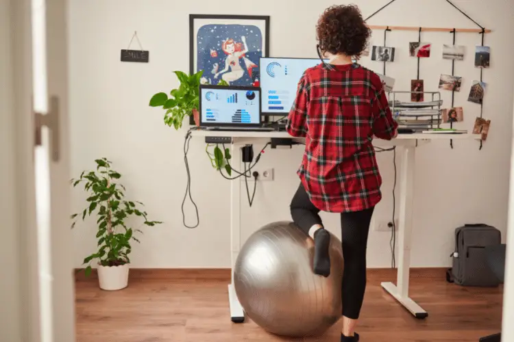 Woman using exercise ball at her desk