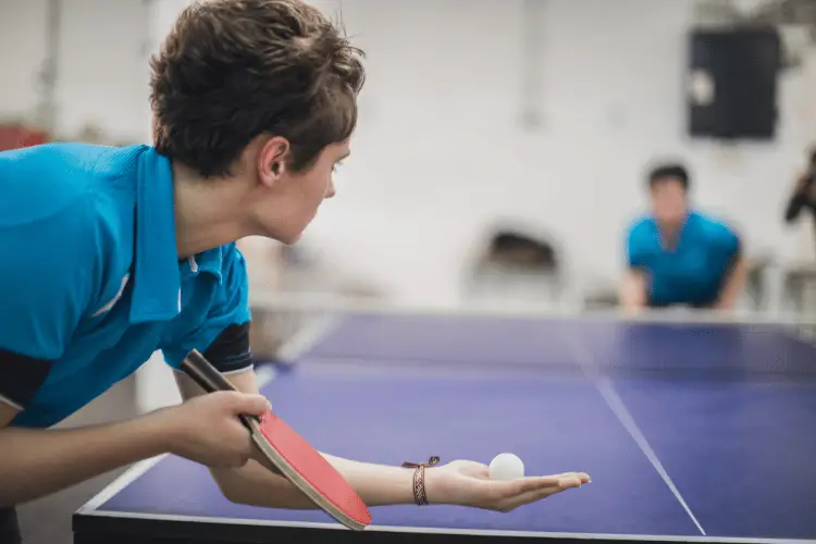 Ping pong player shooting a serve