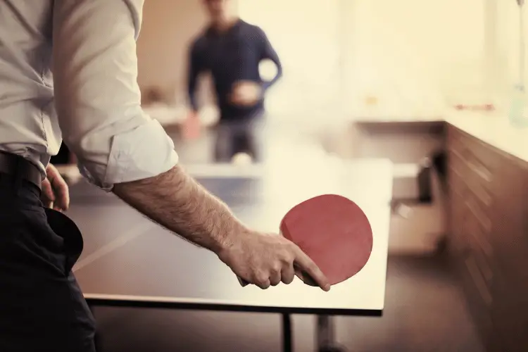 Workers playing ping pong