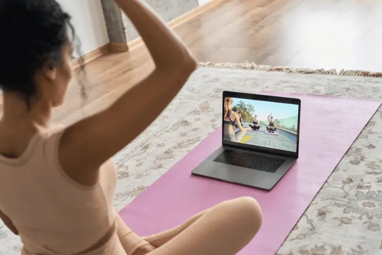 Woman exercising along with an online exercise class
