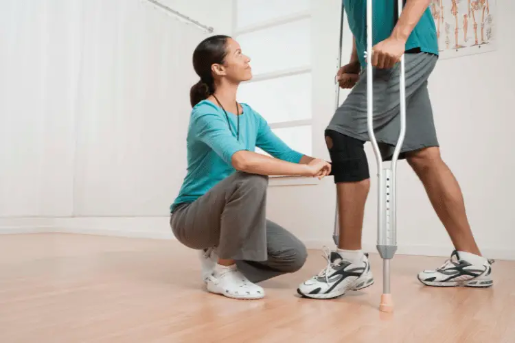 Physical Therapist helping a man with an injured knee