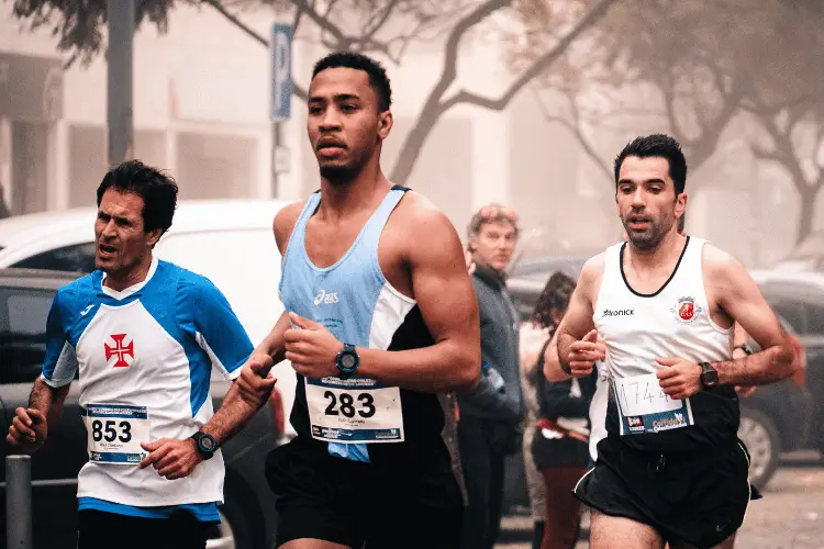 a group of men running in a marathon race 