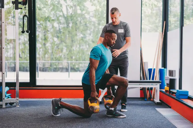 a man doing HIIT exercises with his personal trainer 
