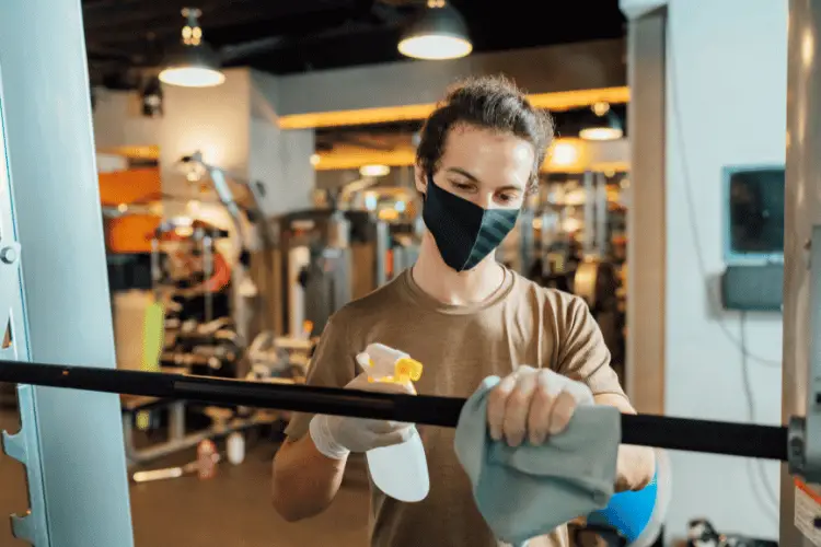 a woman cleansing gym equipment