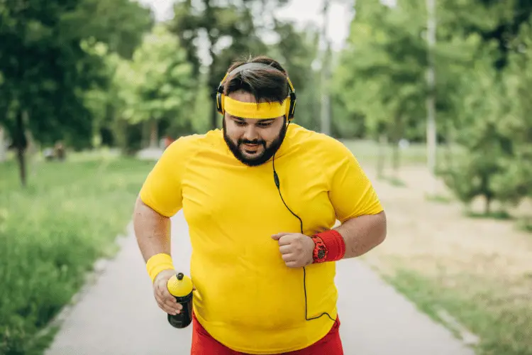 an overweighted man running outdoor 