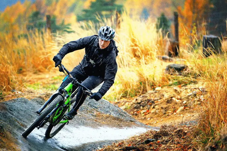 a man biking in the woods in winter