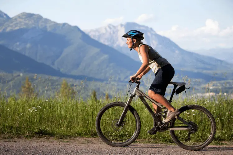 side view of woman doing mountain biking 
