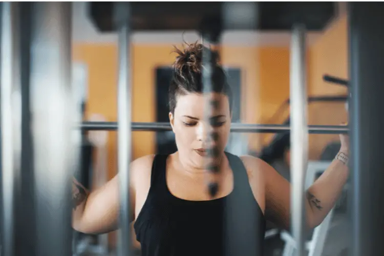 overweighted young woman working out in the gym