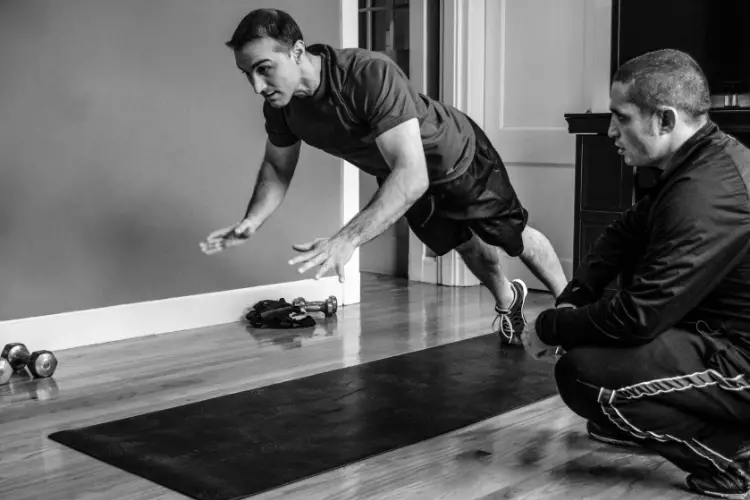 a man working out with his personal trainer 