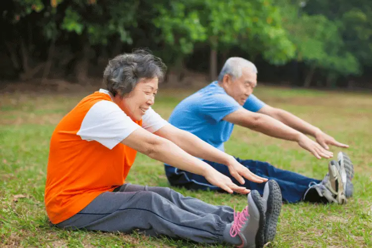 senior couple working out in garden 