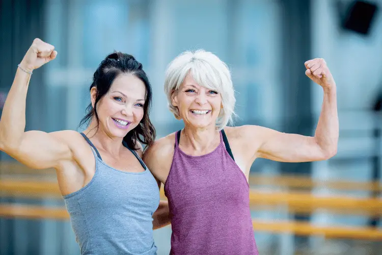 two happy woman showing off their muscles