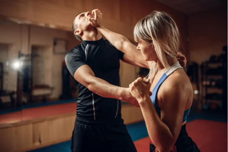 Female person on Self-defense workout with her personal trainer
